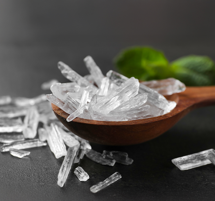 Menthol crystals in wooden spoon